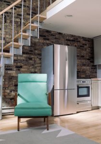teal armchair beside staircase in studio apartment for rent in Chicago