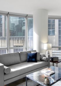 grey sofa and black marble coffee table in living room of a Chicago apartment for rent