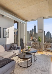 living room with grey sofa and fireplace in downtown Chicago apartment for rent
