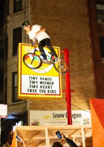 BMX pro Bryce Tryon jumps a ramp set up in front of The Wiener's Circle in Lincoln Park, Chicago