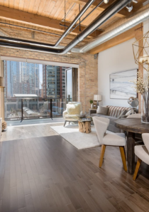 Brick and timber loft in Chicago with spacious living room and doors opening to balcony