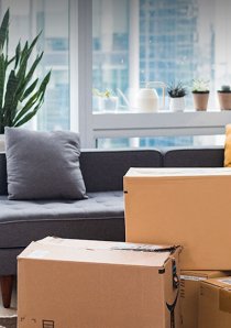 cardboard moving boxes stacked in an apartment living room