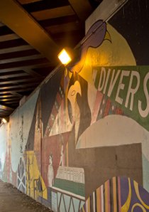 a mural depicting Chicago street signs painted in a viaduct in Chicago