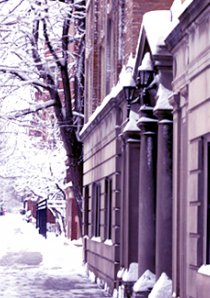 a snow covered sidewalk outside of a Chicago apartment building