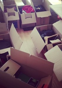 cardboard moving boxes filled with renters' possessions in an apartment living room