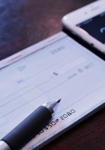 a checkbook with a personal check for apartment security deposit