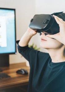 a woman wearing a black VR headset while going on a virtual apartment tour