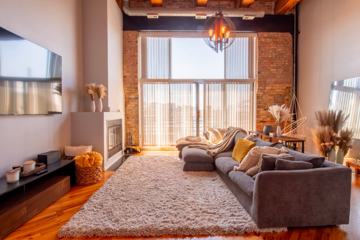 Luxury loft for rent in Lincoln Park with exposed brick, balcony, and hanging swing chair