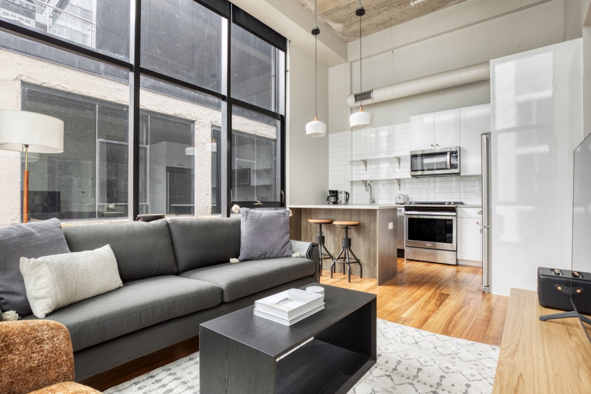 Luxury River North loft with floor-to-ceiling windows and open kitchen