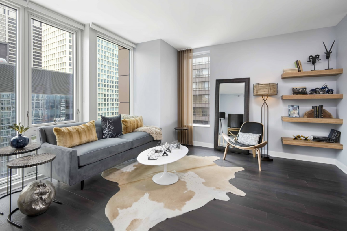 Modern living room with floor-to-ceiling windows at Marquee at Block 37 Apartments in Chicago