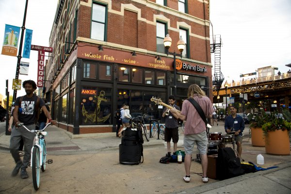 Street musicians on N Milwaukee Ave, W North Ave, and N Damen Ave intersection in Wicker Park Chicago
