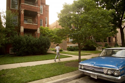 Jogger and vintage car parked on N Glenwood Ave in Edgewater Chicago